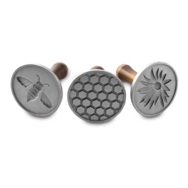 Nordic Ware wooden-handled cookie stamps featuring honeybee designs, three circular aluminum stamps displayed