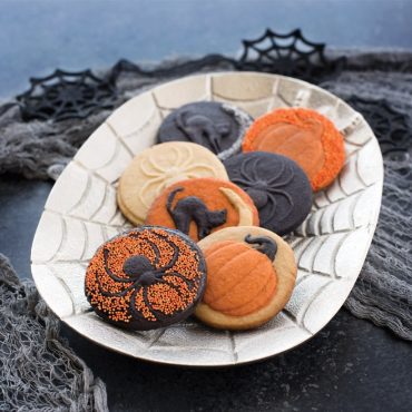 Set of Nordic Ware Halloween cookie stamps with carved pumpkin, ghost, and bat designs for imprinting cookies
