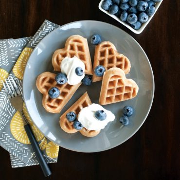 Nordic Ware Sweetheart Waffler with red aluminum base and heart-shaped waffle plates, closed position