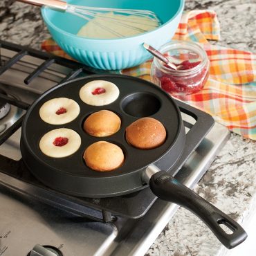 Nordic Ware cast iron Danish ebelskiver pan with seven round wells, black finish, shown from above