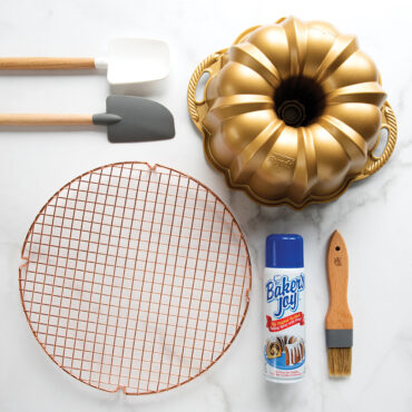 Baker's Joy nonstick baking spray bottle with Nordic Ware baking pans and molds on marble countertop