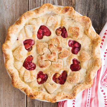 Baked pie with golden lattice heart-shaped cutouts on top crust, showcasing Nordic Ware pie cutter results