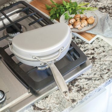 Nordic Ware aluminum frittata pan with dual hinged sections, non-stick dark gray interior, closed position