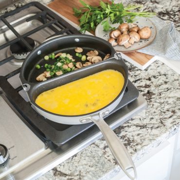 Nordic Ware aluminum frittata pan with golden cooked egg dish containing herbs and vegetables