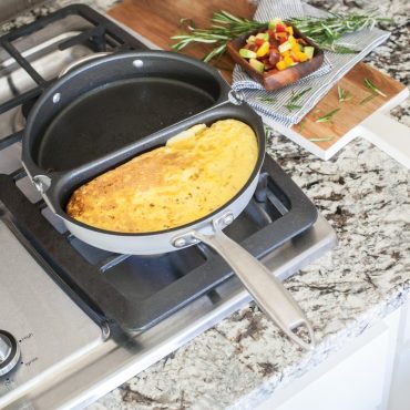 Golden cooked frittata in Nordic Ware non-stick omelet pan, showing fluffy egg texture with herbs and vegetables