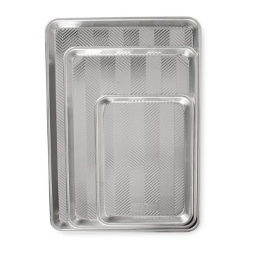Nordic Ware aluminum Prism baking sheet set with three nested pans in natural silver finish, rectangular with raised rims
