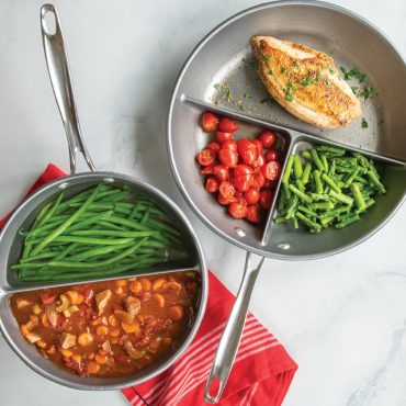 Two Nordic Ware divided pans with cooked food: saucepan with pasta and vegetables, skillet with meat and sides