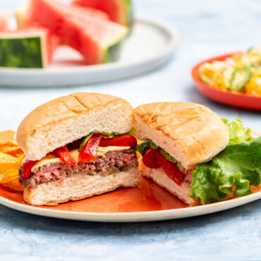 Nordic Ware stuffed burger maker with aluminum press creating thick beef patty with melted cheese filling