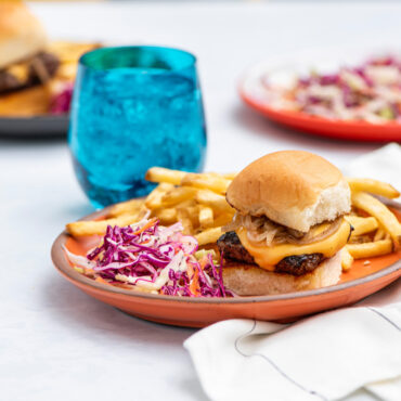 Nordic Ware aluminum stuffed burger maker with hinged press design, silver finish, shown open revealing burger-forming cavities