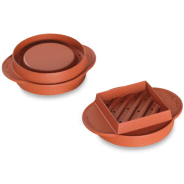 White plastic burger press showing reverse side with circular indentation and handle attachment point