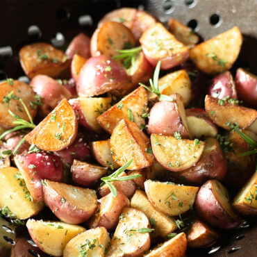Grill Basket filled with diced potatoes, closeup