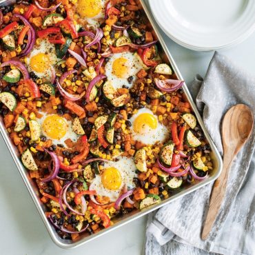 Golden breakfast hash with diced potatoes, peppers, and eggs baked on Nordic Ware aluminum half sheet pan