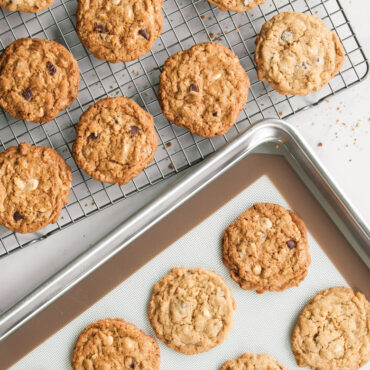 Nordic Ware Naturals aluminum cookie baking set with sheet pan, cooling rack, and freshly baked cookies