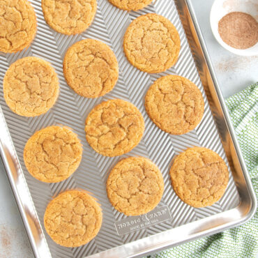 Golden baked cookies cooling on Nordic Ware Prism half sheet pan with textured aluminum surface