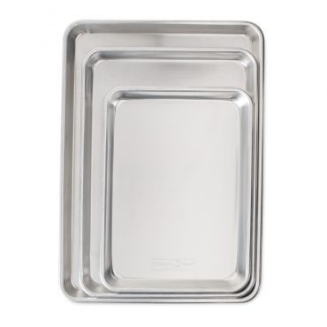 Three nested Nordic Ware aluminum baking sheets in graduated sizes, natural silver finish with raised rims