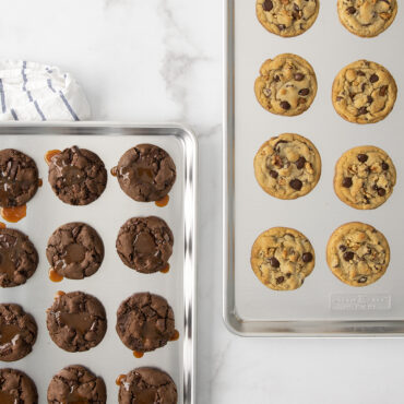 Nordic Ware aluminum big sheet baking pan with golden chocolate chip cookies, natural silver finish
