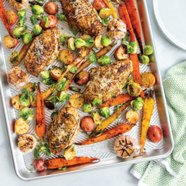 Herb-crusted chicken thighs with roasted carrots and potatoes on Nordic Ware Prism aluminum sheet pan