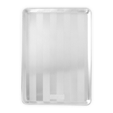 Nordic Ware Prism Big Sheet aluminum baking pan with textured chevron pattern and raised rim