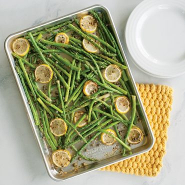 Nordic Ware aluminum jelly roll pan with roasted asparagus spears and lemon slices, natural finish