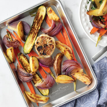 Nordic Ware aluminum quarter sheet pan with colorful roasted vegetables, natural silver finish