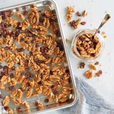 Nordic Ware aluminum quarter sheet baking pan with lid, filled with golden roasted walnuts