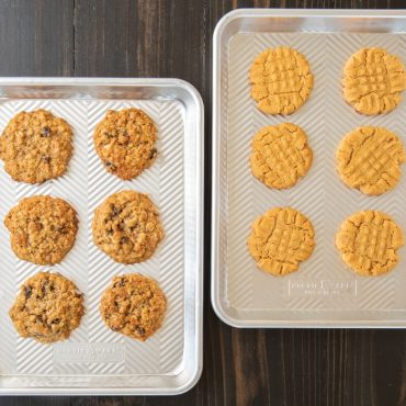 Two Nordic Ware aluminum Prism quarter sheet pans with textured diamond pattern, filled with golden baked cookies