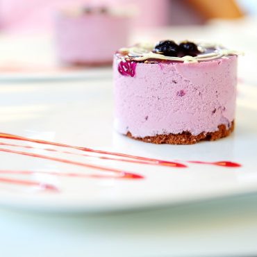 Layered raspberry dessert with graham cracker crust baked in Nordic Ware round aluminum cake pan