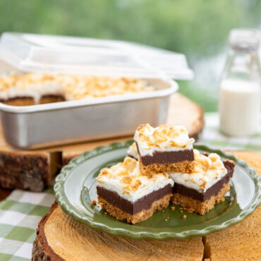 Golden brownies cut into squares on white plate, baked in Nordic Ware Naturals aluminum 9-inch square cake pan