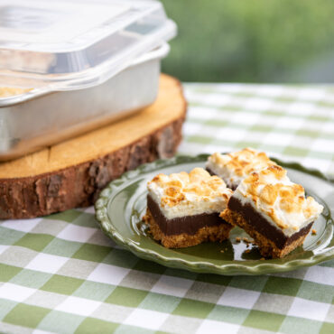 Sliced chocolate brownies arranged on white plate, baked in Nordic Ware natural aluminum square cake pan