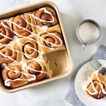 Nordic Ware aluminum square baking pan with golden baked cinnamon rolls arranged in rows
