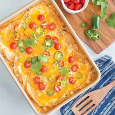 Baked puff pastry tart with melted cheese, sliced jalapeños and cherry tomatoes in Nordic Ware nonstick rectangular pan