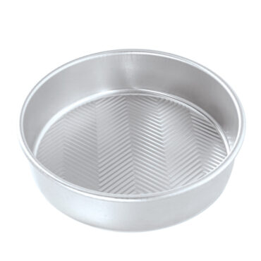 Nordic Ware aluminum 9-inch round cake pan with geometric chevron pattern interior, silver finish