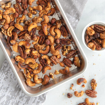 Golden candied nuts spread on Nordic Ware Prism aluminum eighth sheet pan with raised edges