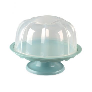 Nordic Ware white ceramic bundt cake stand with pedestal base displaying golden bundt cake with glaze