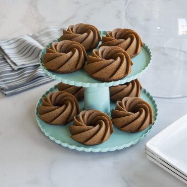 Nordic Ware 2-tiered aluminum dessert stand displaying golden Heritage Bundtlettes on both levels