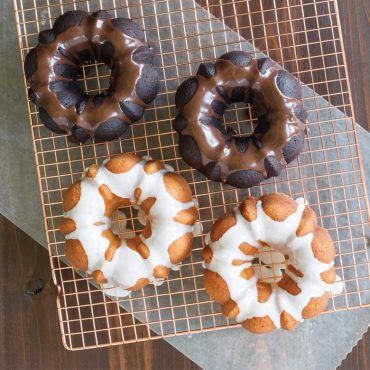 Two glazed bundt cakes from Nordic Ware 3-cup pan, one chocolate one vanilla, overhead view showing fluted details