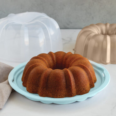 Nordic Ware aluminum bundt pan with translucent sea glass green dome cake keeper cover