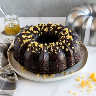 Golden bundt cake with crystallized ginger pieces baked in Nordic Ware fluted aluminum bundt pan