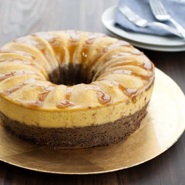 Layered chocoflan dessert baked in Nordic Ware aluminum bundt springform pan with golden caramel topping