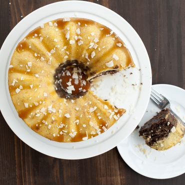 Sliced chocoflan dessert baked in Nordic Ware bundt springform pan with caramel drizzle, overhead view