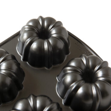 Nordic Ware aluminum Bundtlette pan with six individual fluted bundt cake molds, bronze non-stick finish