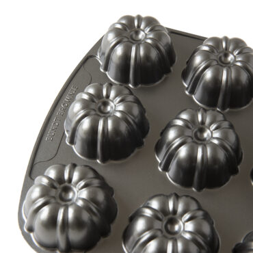 Nordic Ware aluminum bundt brownie pan with six individual fluted cavities, bronze non-stick finish