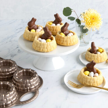 Golden shortcake basket cakes filled with fresh berries and topped with chocolate Easter bunnies