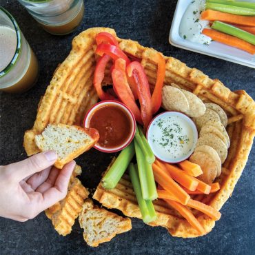 Golden pull-apart cheese bread baked in Nordic Ware Stadium Bundt pan with dips and vegetables in center well