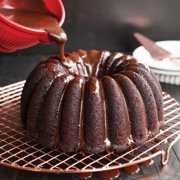 Chocolate bundt cake with glossy chocolate ganache glaze baked in Nordic Ware Elegant Party bundt pan