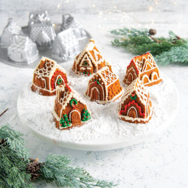 Golden brown gingerbread houses from Nordic Ware Cozy Village pan with white icing details