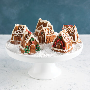 Golden brown gingerbread houses from Nordic Ware Cozy Village pan with white icing details