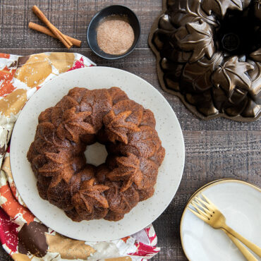 Golden pumpkin bundt cake in Nordic Ware Harvest Leaves bundt pan showing detailed leaf pattern design