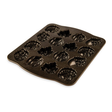 Nordic Ware Autumn Cakelet Pan showing bronze nonstick interior with six autumn-themed cavities
