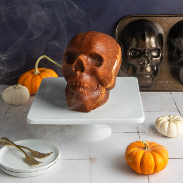 Haunted Skull Cake on white cake stand with dry ice mist